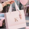 Luxury pink paper shopping bag with ribbon handles for gift packaging