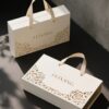 Luxury book style magnetic gift packaging box with handle and floral cutout design